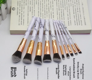 Flat lay of 10-piece marble texture makeup brushes with rose gold metal and soft bristles