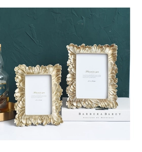 Close-up of vintage golden embossed photo frames with petal texture in luxury room