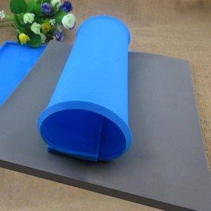 Blue silicone swiss roll baking mat showing rolled and flat textures for cakes