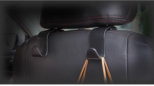Close-up of black multifunctional car seat headrest hooks for interior organization