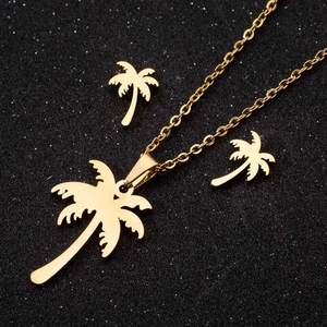 Bohemian gold coconut tree jewelry set with leaf earrings and necklace on black background