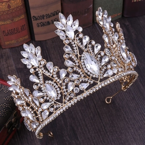 Macro detail of royal gold crown featuring sparkling clear crystals and vintage rhinestones