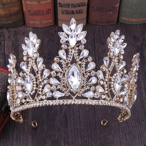 Elegant gold bridal crown featuring clear rhinestones and marquise crystals on dark background