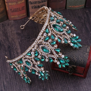 Detail of golden bridal crown with emerald green teardrop crystals and clear rhinestones
