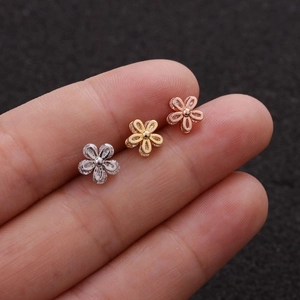 Three tiny five-petal flower piercing studs in silver, gold and rose gold finishes