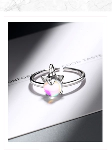 Detailed view of unicorn ring with adjustable band and iridescent opal gemstone