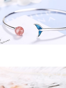 Macro view of silver fish tail bracelet with pink strawberry quartz crystal bead detail