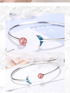 Detailed view of silver fish tail bracelet featuring a pink strawberry quartz stone