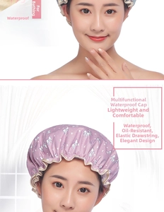 Macro detail of waterproof purple shower cap with white bow pattern and elastic edge