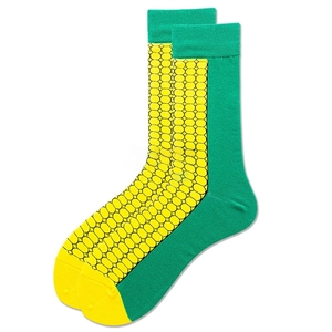Macro detail of mid-calf socks with creative yellow corn kernel pattern and green leaves