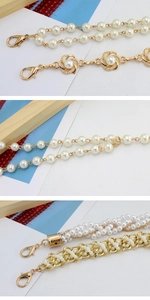 Detail of elegant white pearls and gold metal chain links with lobster clasps