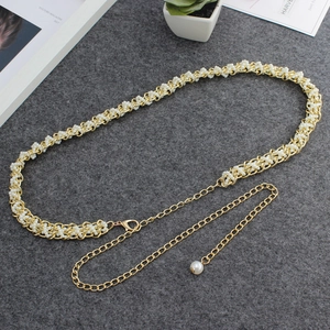 Detail of beaded pearl waist chain with gold metal links and adjustable extender