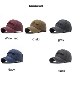 Detail view of cotton baseball caps showing 3D embroidery and washed vintage fabric textures
