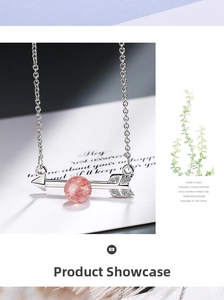 Macro shot of silver arrow pendant with pink strawberry quartz and pavé set crystals