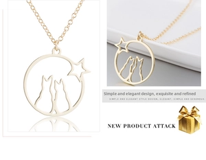 Detailed close-up of golden cat and star hollow circular pendant necklace with fine chain