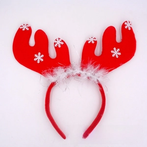 Detail of red reindeer horn headband with white snowflake patterns and silver sequins