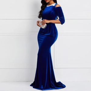 Close-up of luxurious navy blue velvet fabric with elegant off-shoulder evening gown details