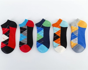 Flat lay view of five pairs of cotton low cut socks with colorful diamond argyle patterns