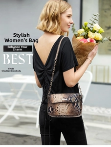Detailed close-up of snake pattern texture and metal chain strap on woman crossbody bag