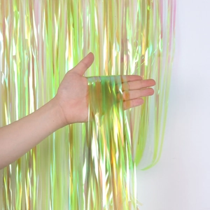 Detail of iridescent yellow-green fringe curtain for party backdrops with shiny finish