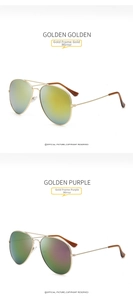 Detail of aviator sunglasses with gold metal frames and reflective mirror lenses