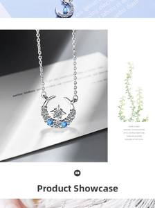 Close-up of star and moon pendant necklace with inlaid blue stones and white zircons