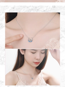 Detail of moon and star necklace with blue crystal drops and sparkling diamond accents