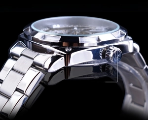 Macro shot of the classic non-slip crown and polished silver steel case of the watch