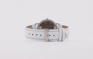 Close-up of white leather watch strap with silver buckle and detailed stitching