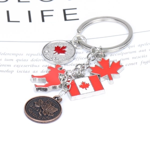 Zinc alloy Canada keychain with red maple leaf, moose charm, and 1 cent coin pendant
