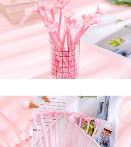 Detail of soft pink cherry blossom silicone topper on 0.5mm gel pen for students
