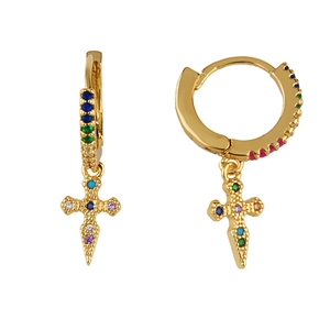 Detail of golden hoop earrings with colorful zircon stones and hanging cross charms