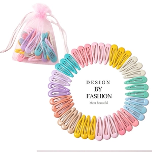 Macro detail of teardrop hair clips in colorful macaron shades with pink mesh storage bag