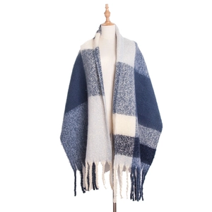 Close-up of thick blue and white checkered scarf with soft fringe details