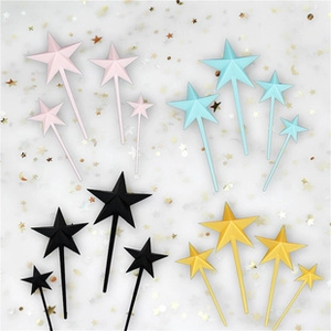 Star-shaped cake toppers in pink blue black and gold colors for birthday parties