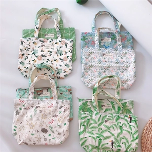 Flat lay of multiple cotton canvas tote bags with floral and animal print patterns