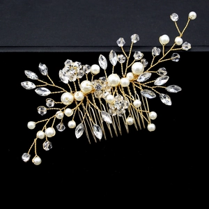 Detail of bridal hair comb with gold wires, white pearls and sparkling crystal flowers