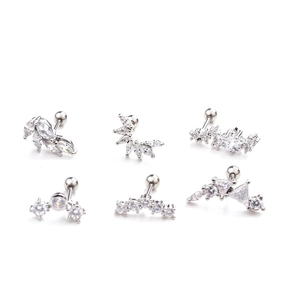 Macro detail of silver stainless steel cartilage studs set with clear zircon stones