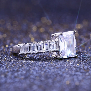 Macro shot of an emerald cut cubic zirconia ring with channel set side stones