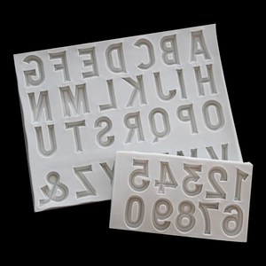 Silicone alphabet and number molds for fondant, chocolate and cake decoration on black background
