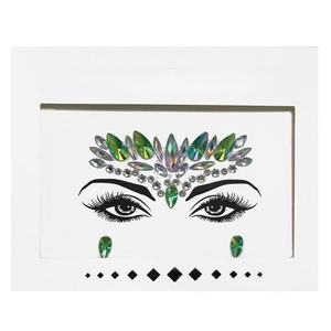 Detail of green iridescent face crystal stickers with diamond and teardrop gems