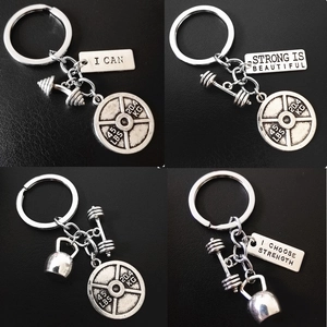 Silver fitness keychain set featuring dumbbell, kettlebell and barbell pendants