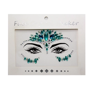 Close-up of peacock green crystal face sticker set with resin gems on white card