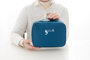 Close-up of waterproof dark cyan travel bag featuring reinforced handle and zipper detail