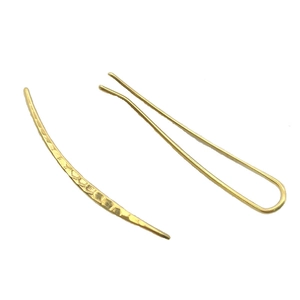 Golden U-shaped hair clip and curved pin with hammered texture on white background