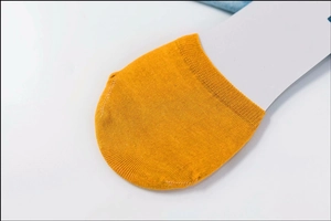 Close-up of mustard yellow cotton boat socks showing toe seam detail and knitted texture
