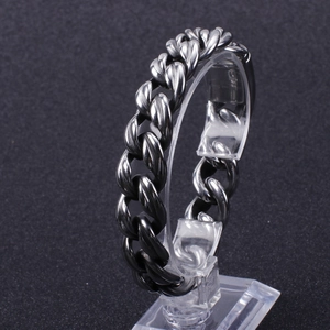 Men's titanium steel Cuban chain bracelet in silver-grey finish on a display stand