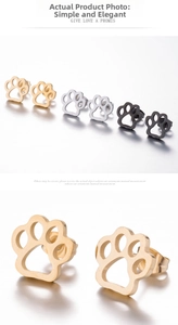 Close-up of hollowed-out animal paw print studs in gold, silver, and black finishes