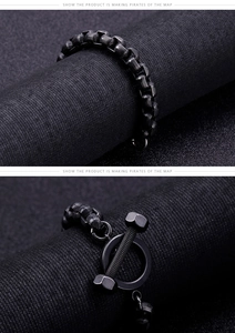 Detailed macro view of black industrial style dumbbell chain bracelet with OT toggle clasp