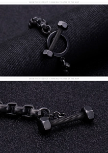 Detailed view of matte black dumbbell bracelet with industrial T-bar clasp and knurled texture